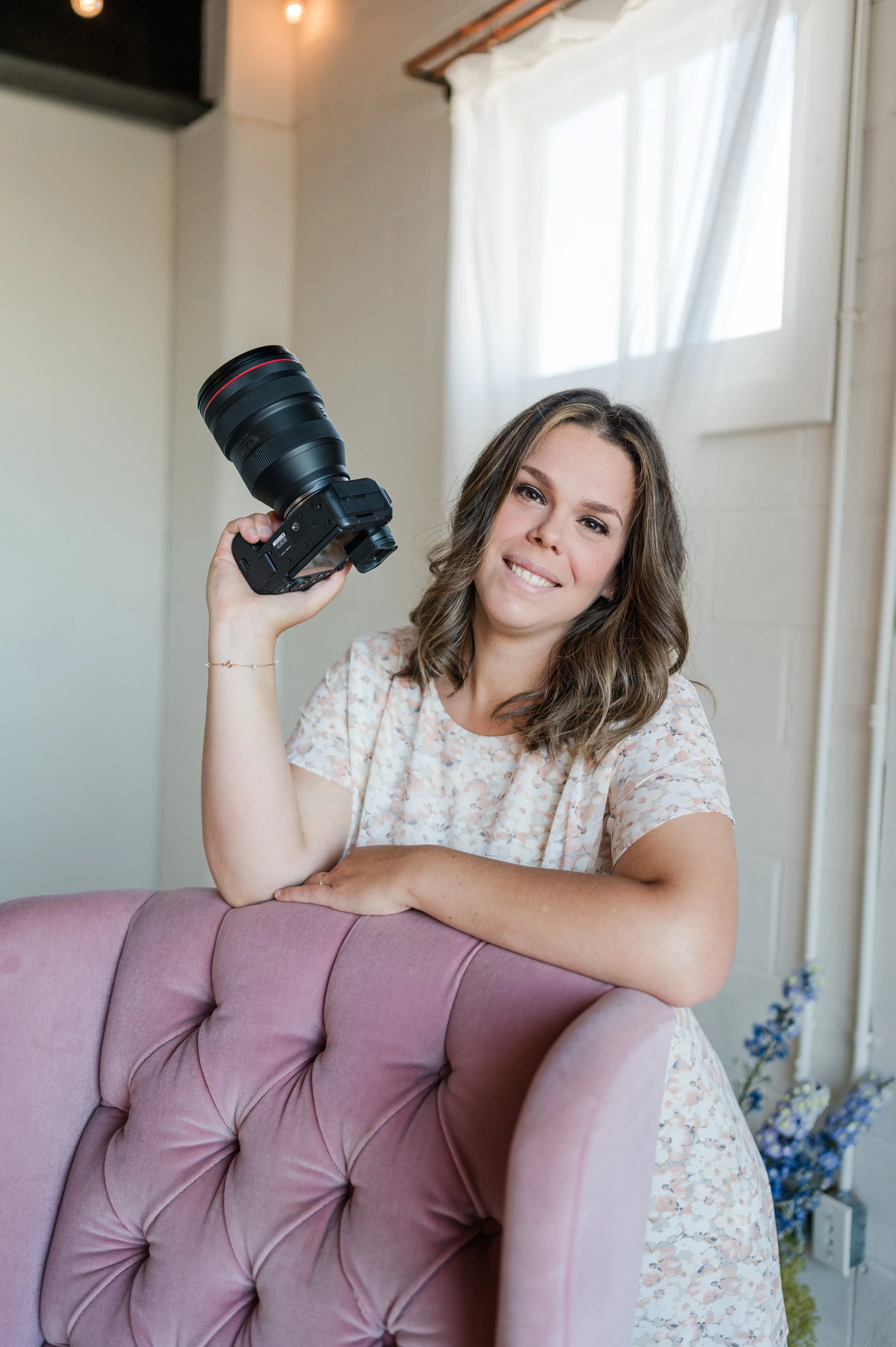 audrey photography during a branding session holding her camera and smiling