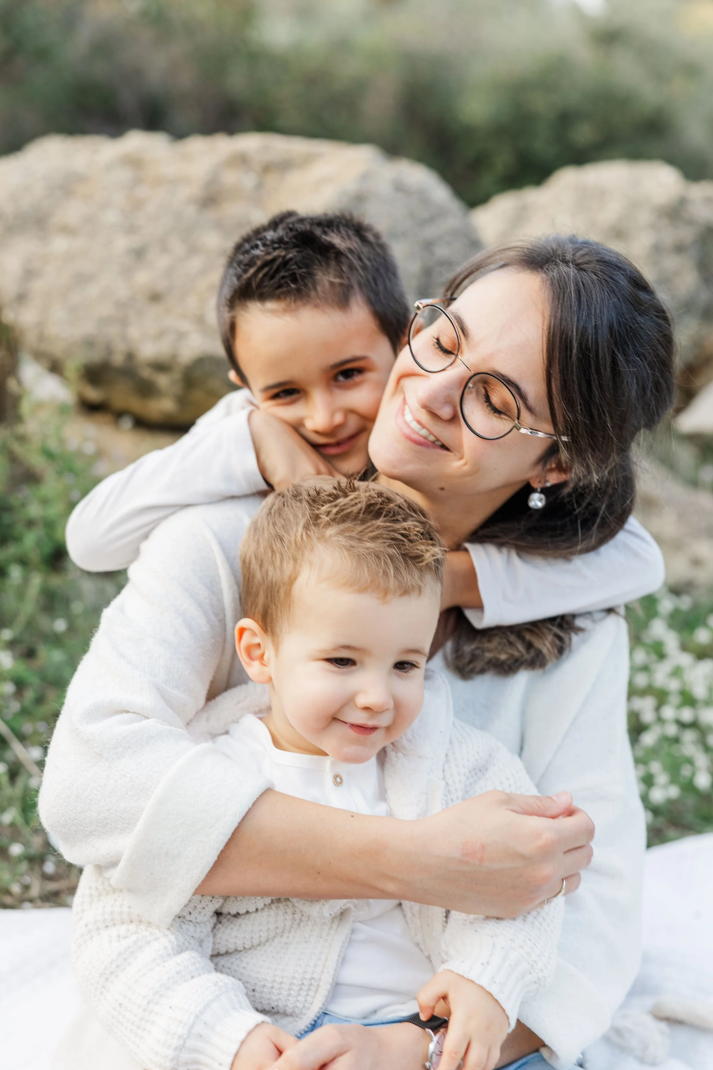 mother and her sons in Provence, smiling in a olive grove in south of France