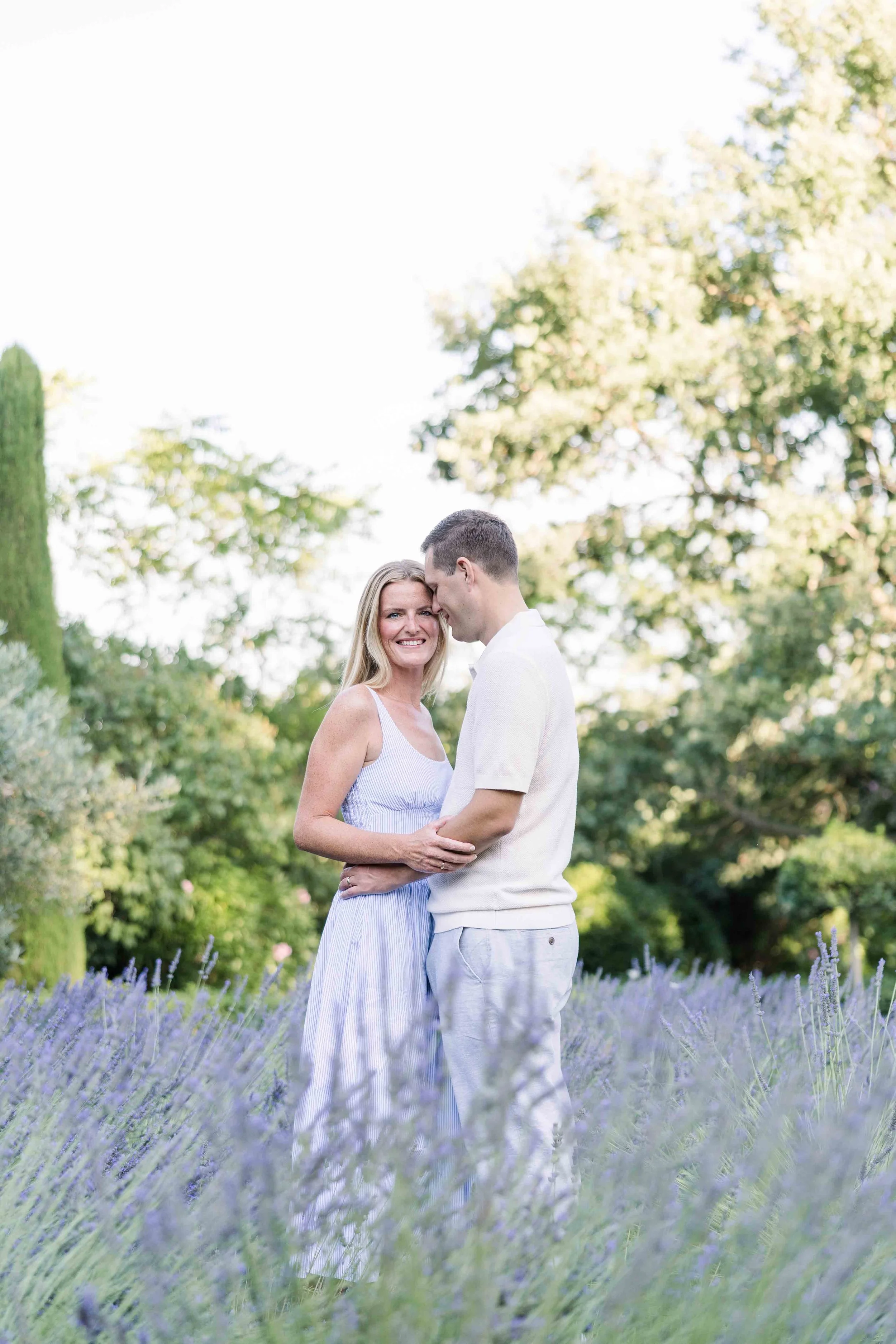 Couple embracing in a lavender field at Domaine de Fontenille, Lauris, during their 10 year anniversary session in Provence
