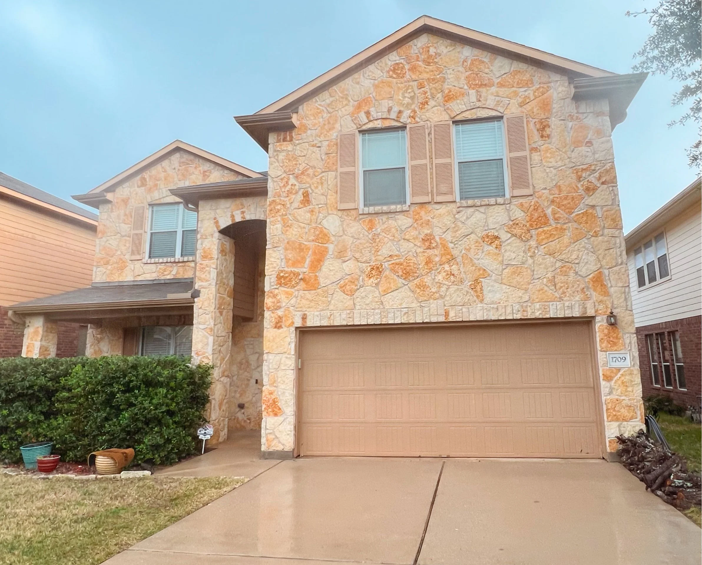 A 2 story flagstone home that is sparkling clean from a fresh soft wash.