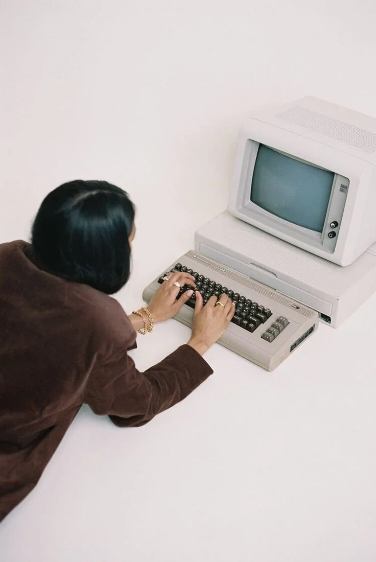 Woman typing on an analog computer