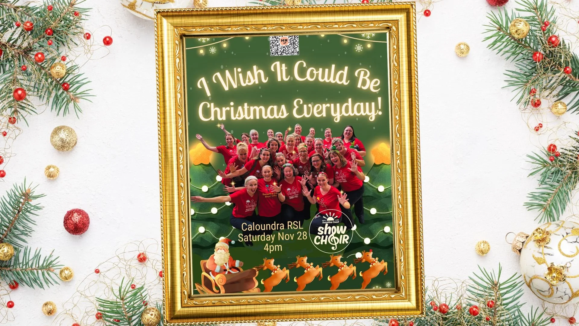 A festive poster inside a gold frame promotes a Christmas event. The poster features a group of women in red shirts, smiling and waving, with a Christmas theme including Santa Claus in a sleigh and reindeer. The text reads 'I Wish It Could Be Christmas Everyday!' and provides event details: Caloundra RSL, Saturday, Nov 28 at 4 pm, organized by Sunshine Coast Show Choir.