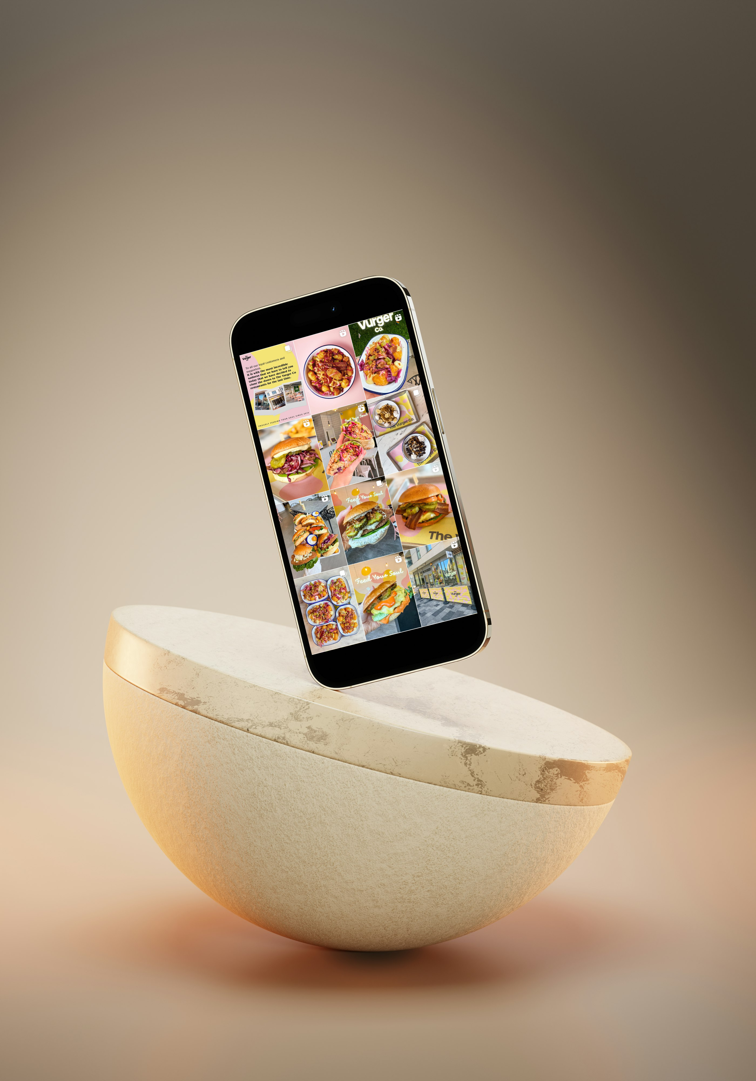 Smartphone displaying food images, balanced on a curved beige stone surface against neutral background.