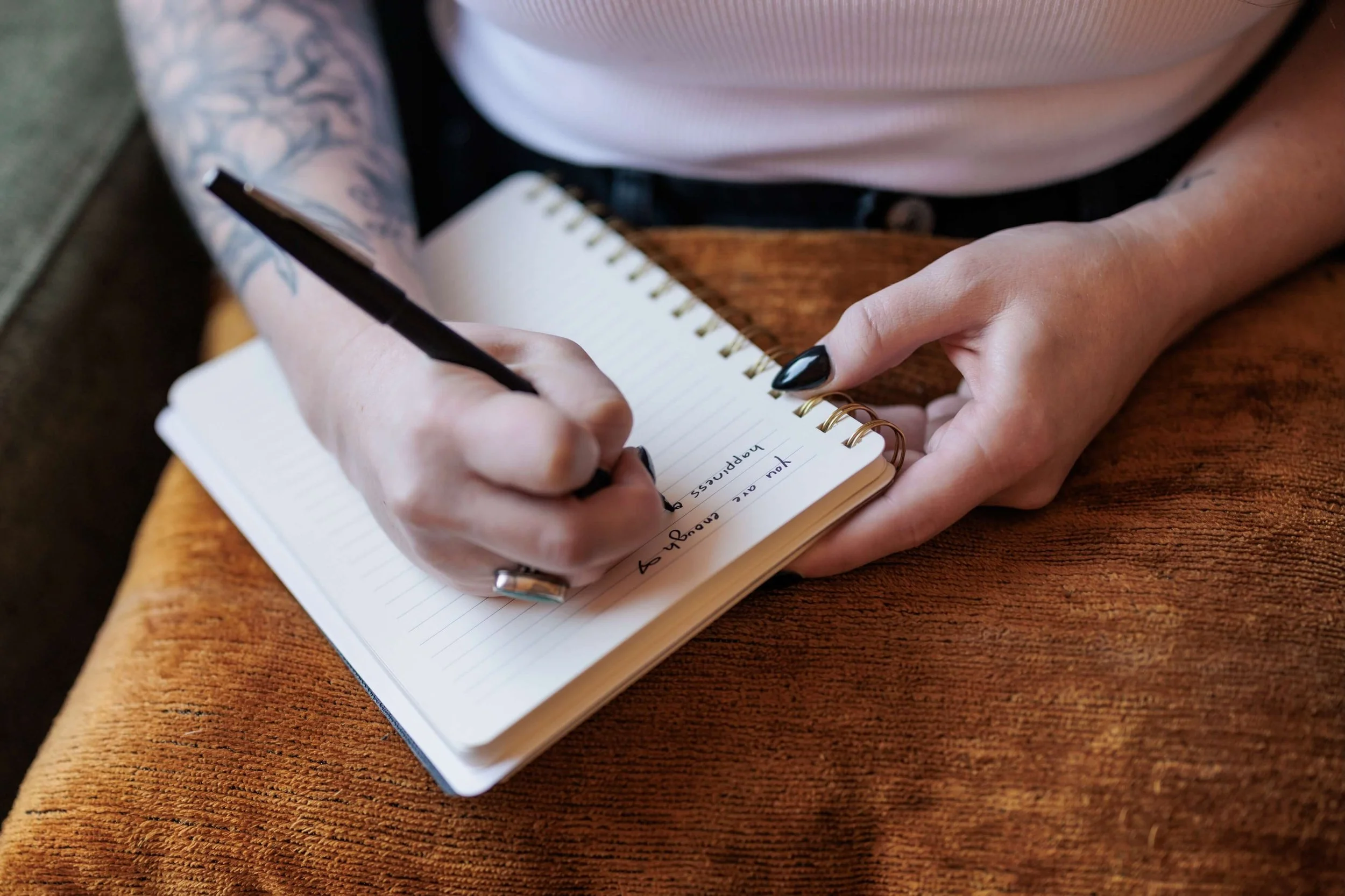 Kaylie writes in a lined notebook.