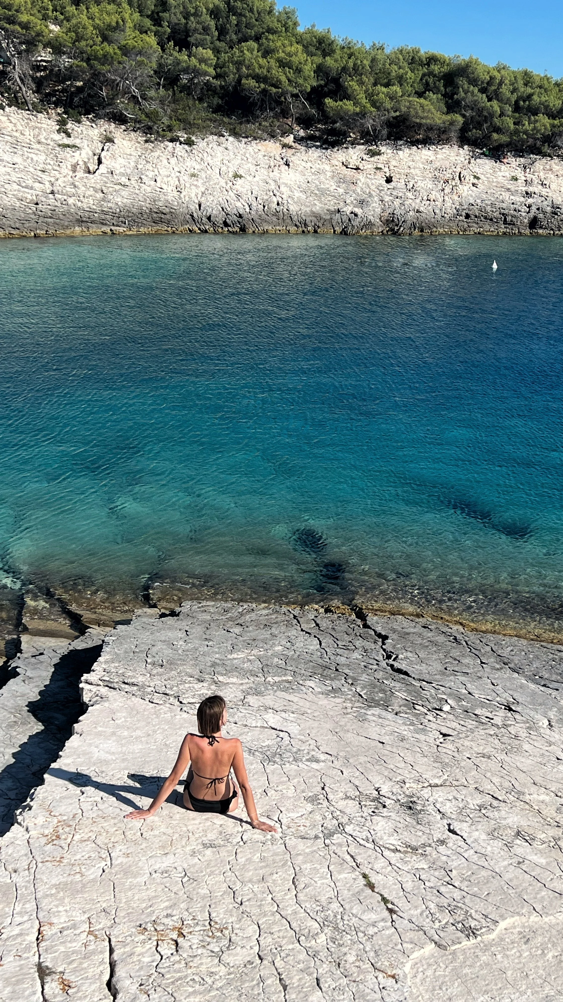 Pose in bikini and make instagram signature photos and memories with photos on rocky shore of the island of Vis.