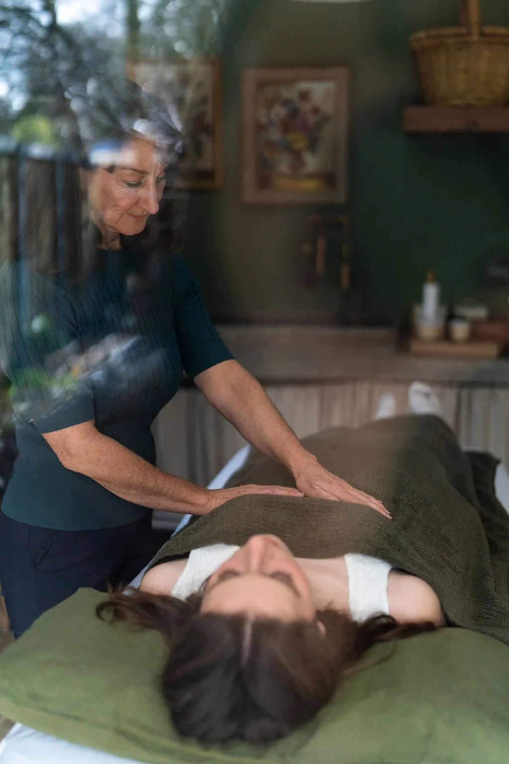 me at reiki table through window.jpg