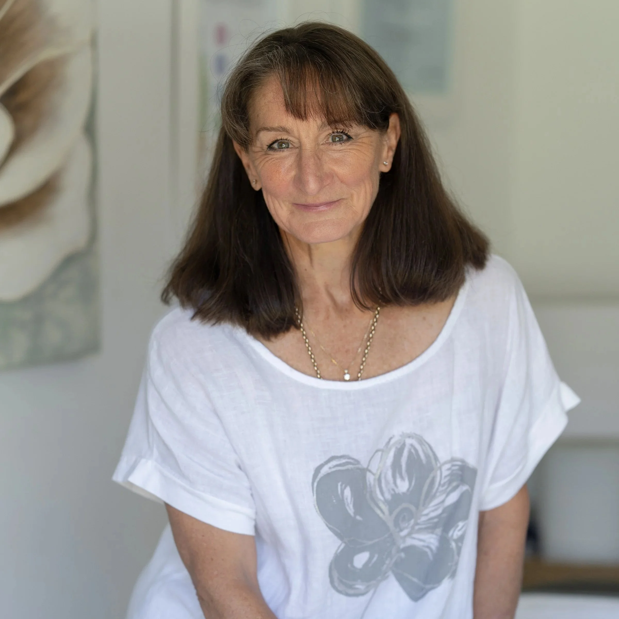 two ladies chatting outdoors at table with coffee