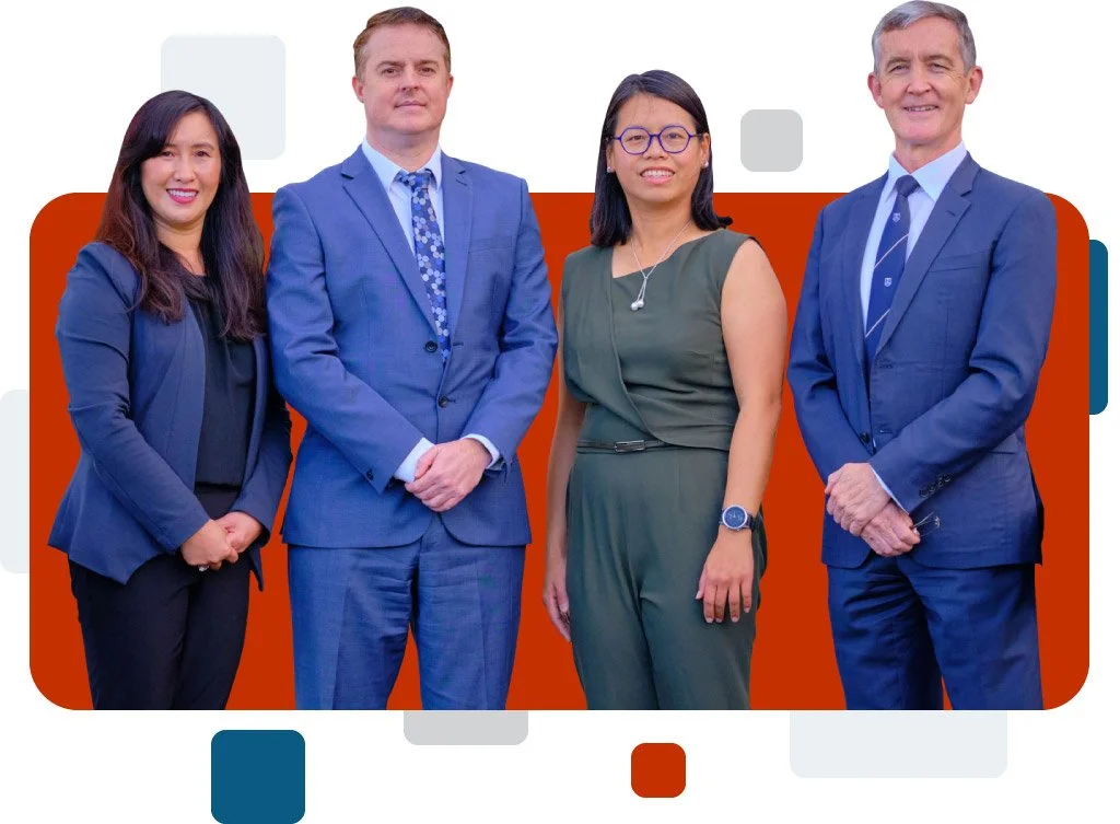 Four professionally dressed individuals standing together in front of a graphic background with geometric shapes and colors.