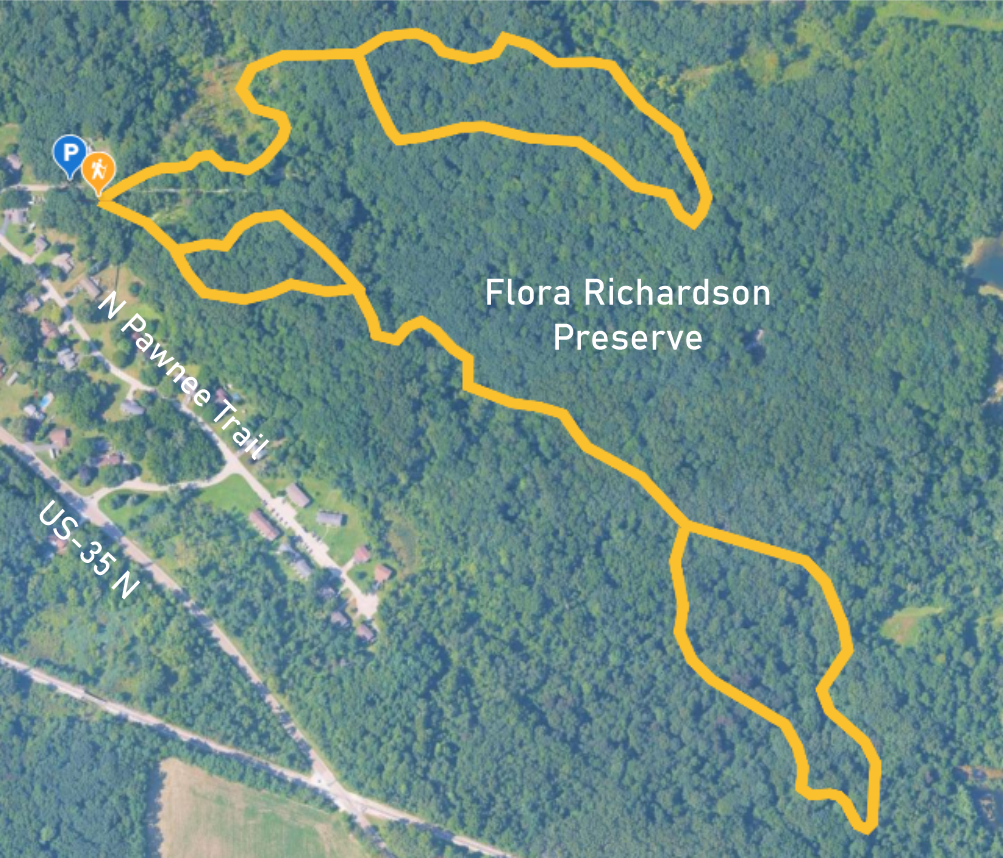 Satellite map of Flora Richardson Preserve with a marked trail in yellow, parking and trailhead icons, and nearby residential area and road.