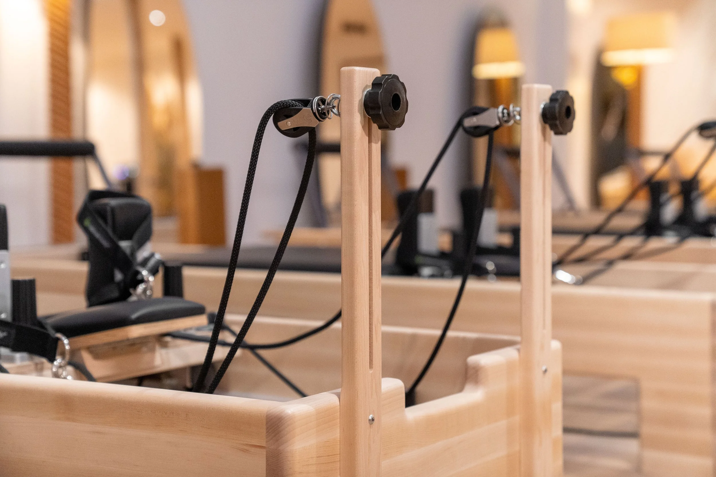 Photos d'une machine de Pilates Reformer en bois clair de la marque Balanced Body