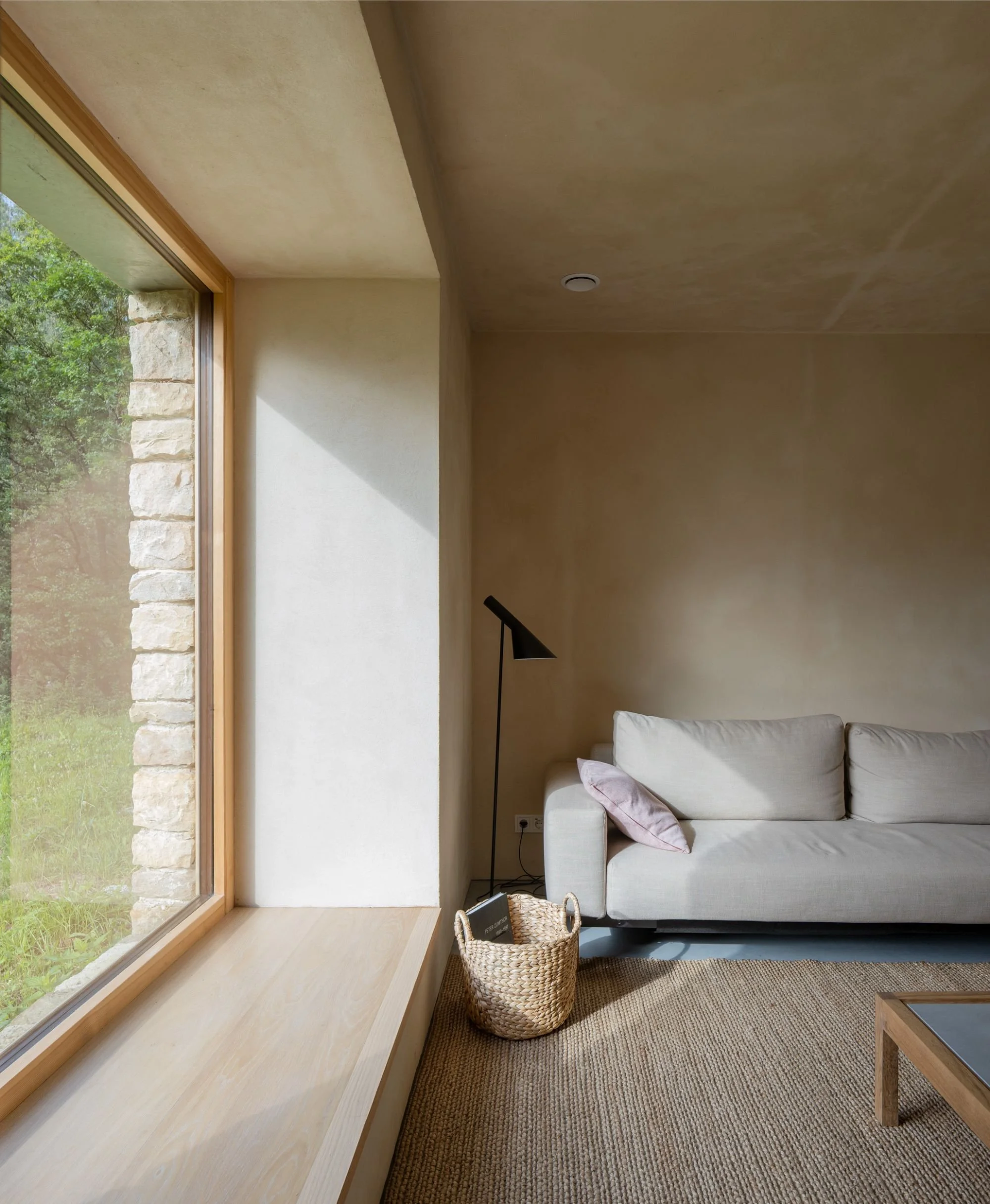 Living room with beige sofa, wooden coffee table and rug.