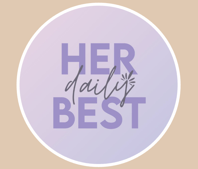 A circular graphic with a light purple background and white border, featuring the text 'Her Daily Best' with 'Her' and 'Best' in large purple font and 'daily' in cursive black font.