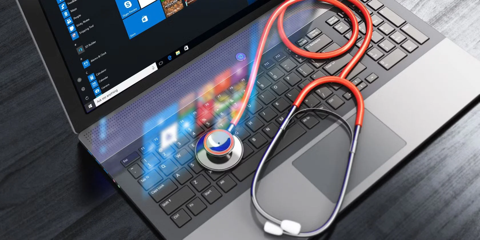 A laptop computer with a stethoscope placed on the keyboard, symbolizing telemedicine or digital health.