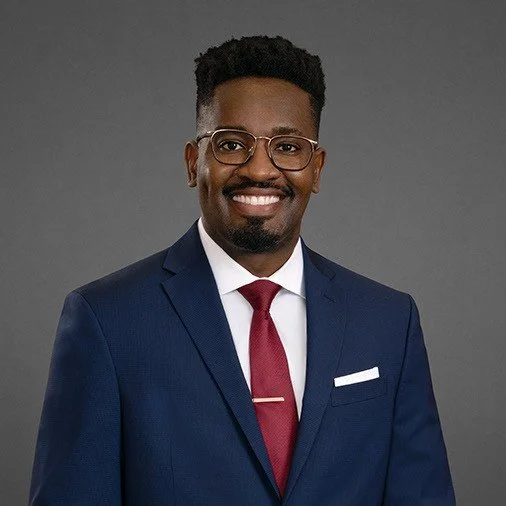 Silhouette of a person's head and shoulders, facing forward.