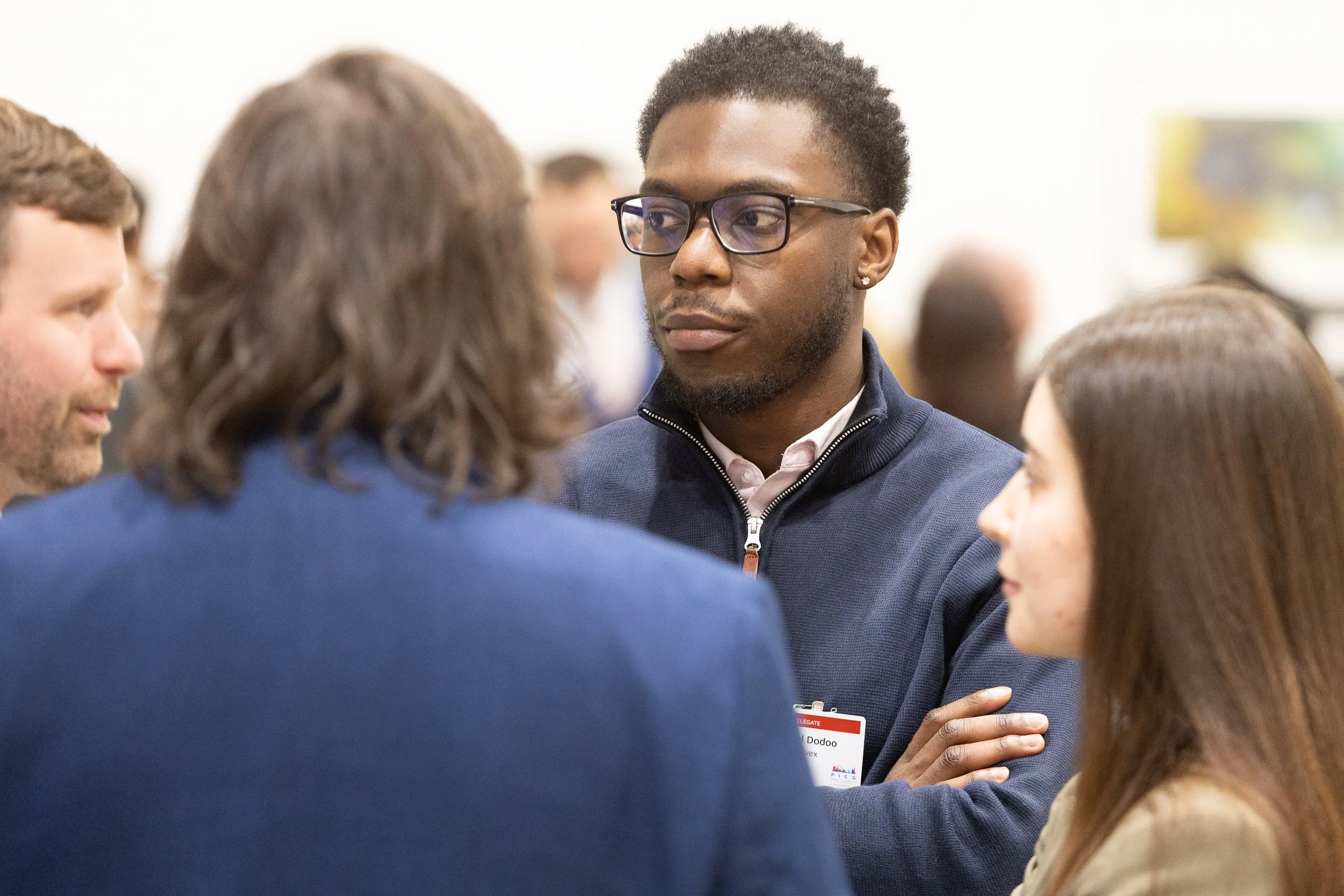 People engaged in conversation at a professional networking event.