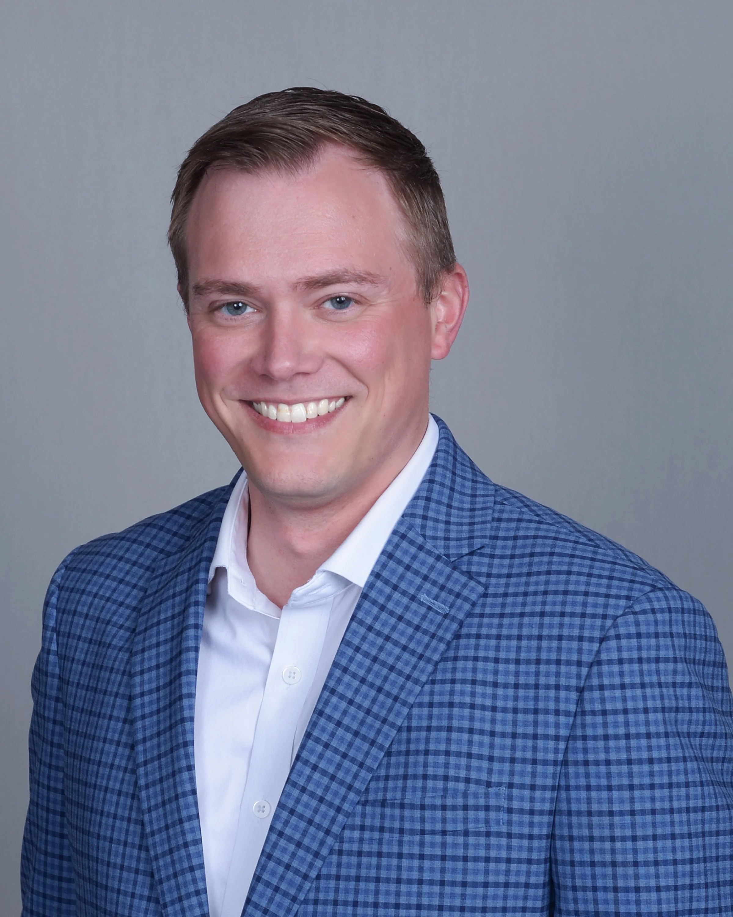 Silhouette of a person's head and shoulders, facing forward.