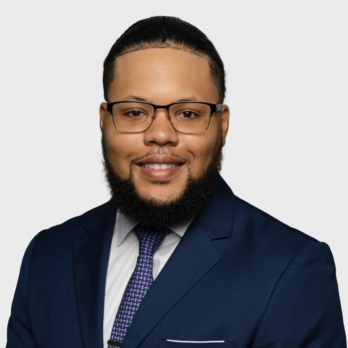 Silhouette of a person's head and shoulders, facing forward.