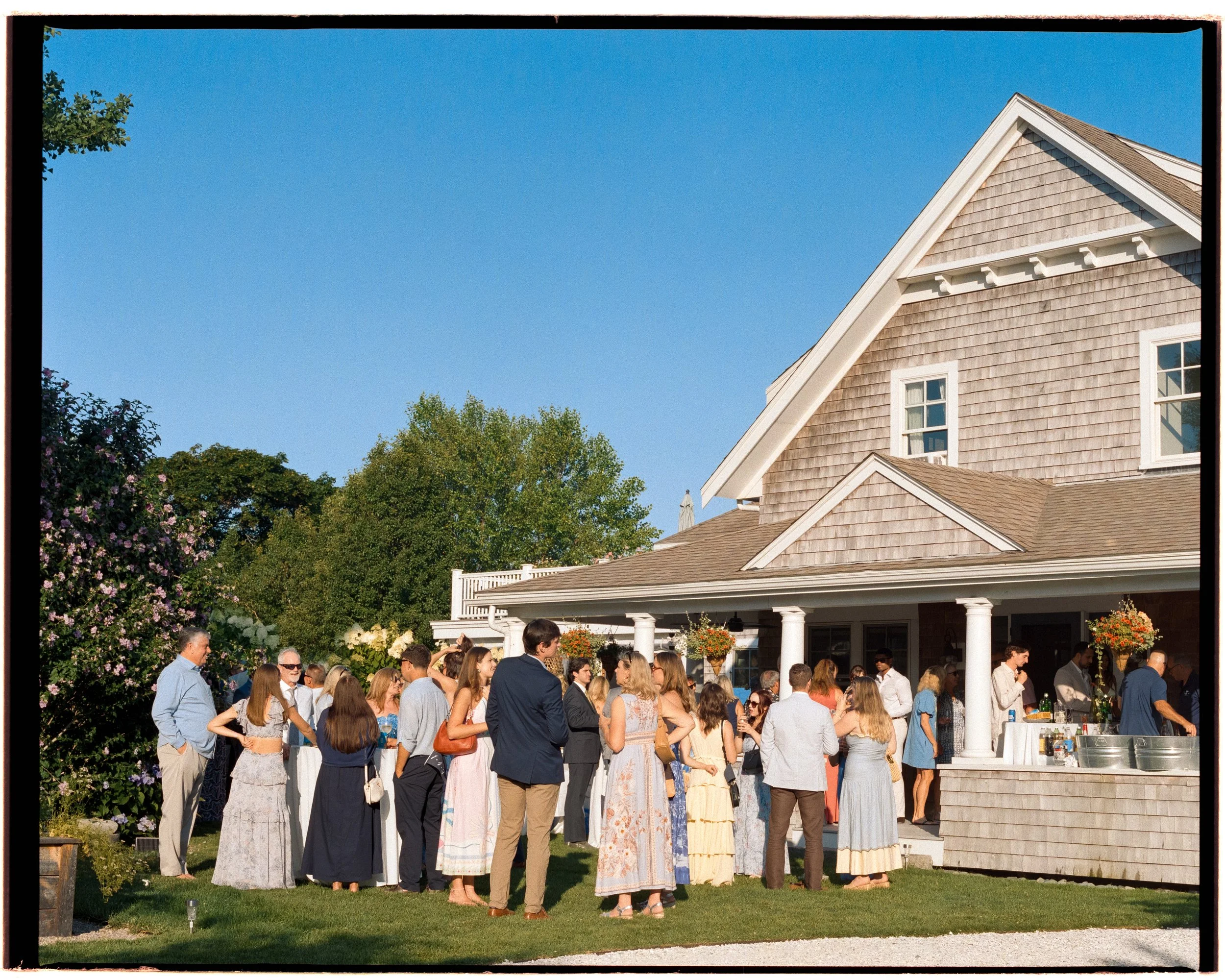 Its a beautiful day on Cape Cod, guests are gathered outside the family home waiting to celebrate the happy couple.