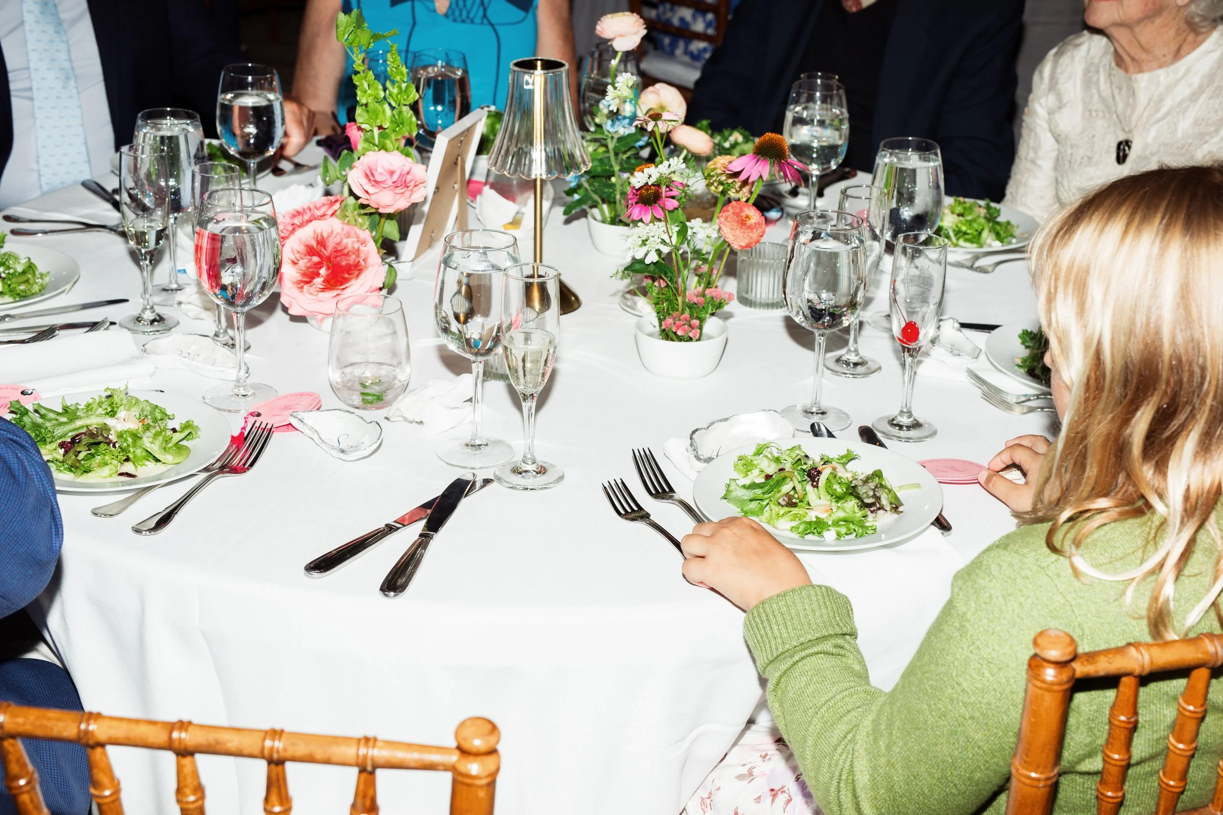 The guest's wedding table is set and the first course, salad is served.
