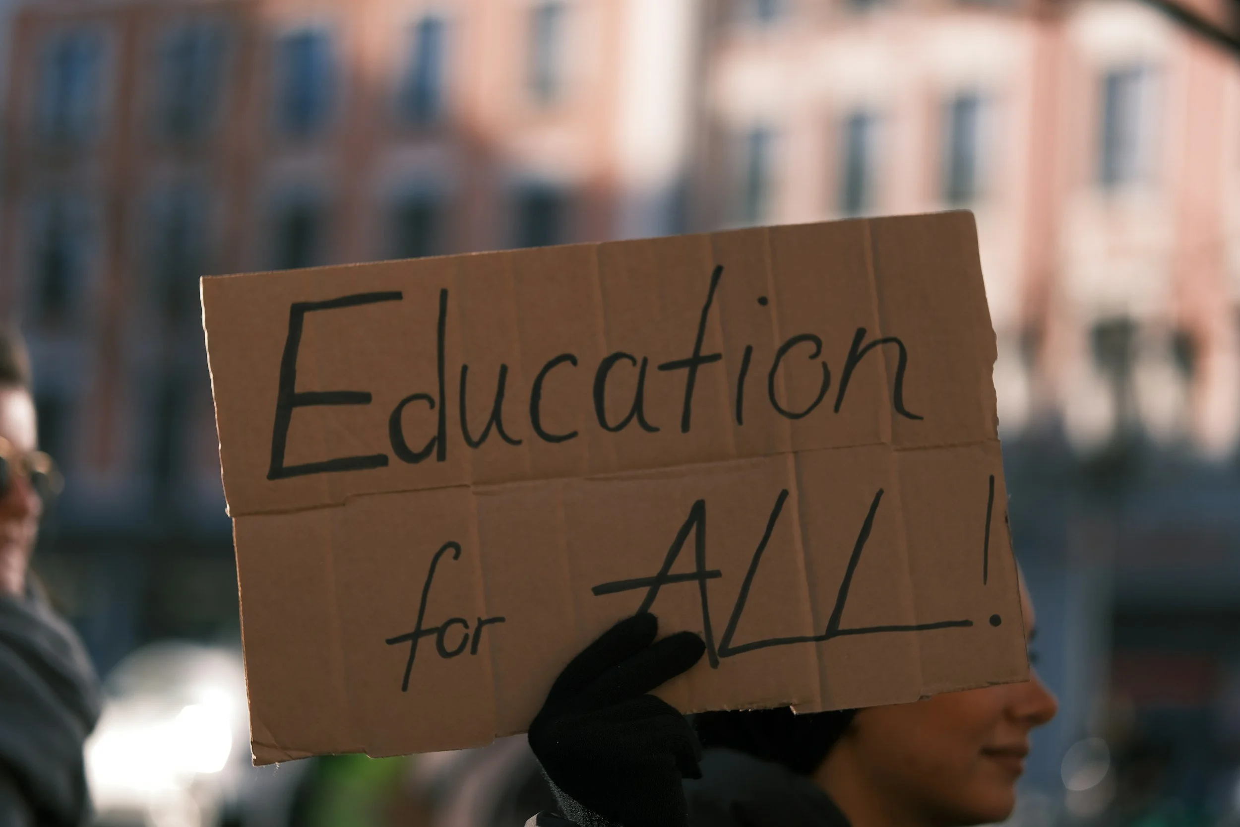 “Sign reading ‘Education for all’, representing inclusive education and advocacy for neurodivergent children”