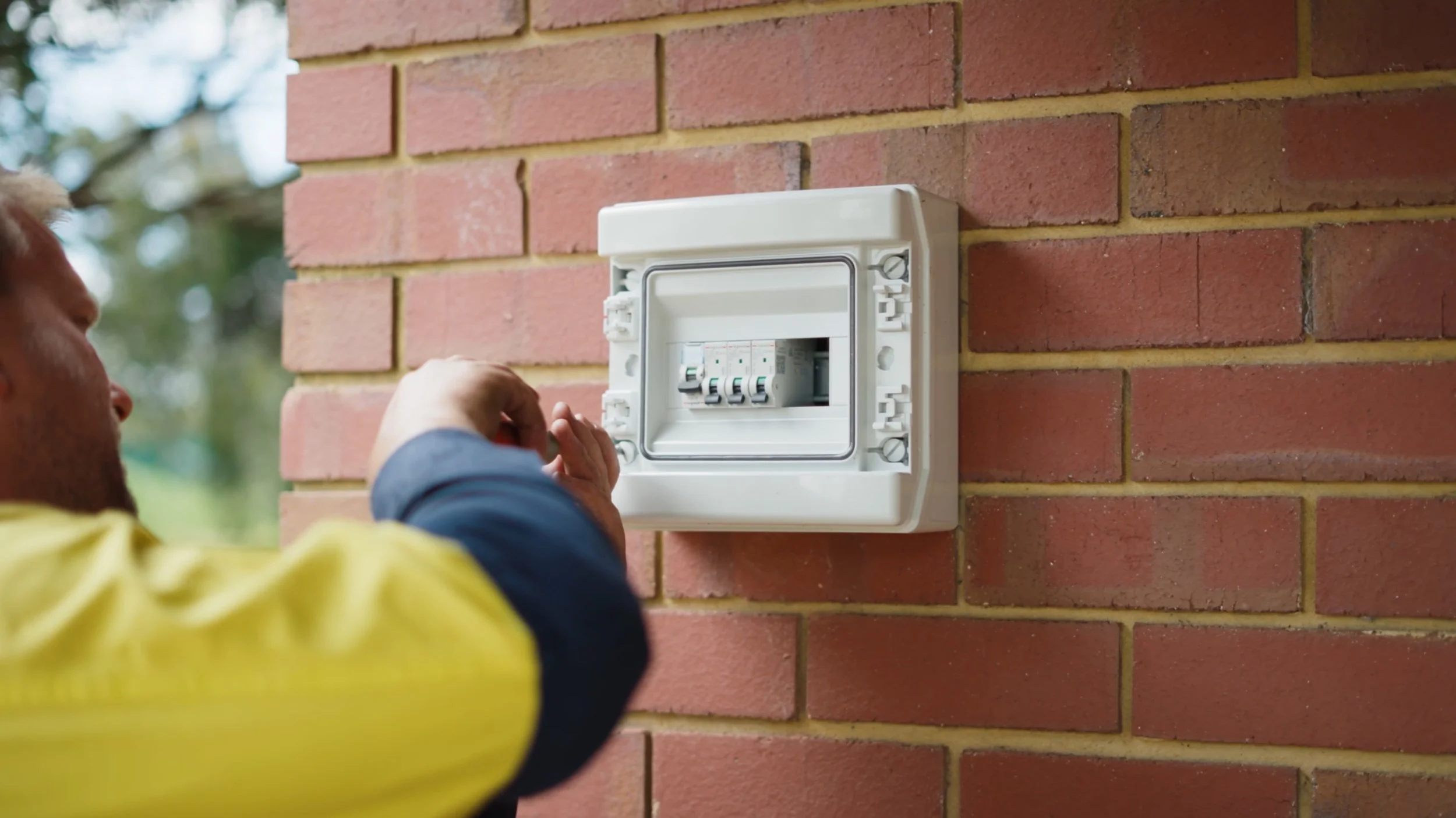 Electrician working on fuse box