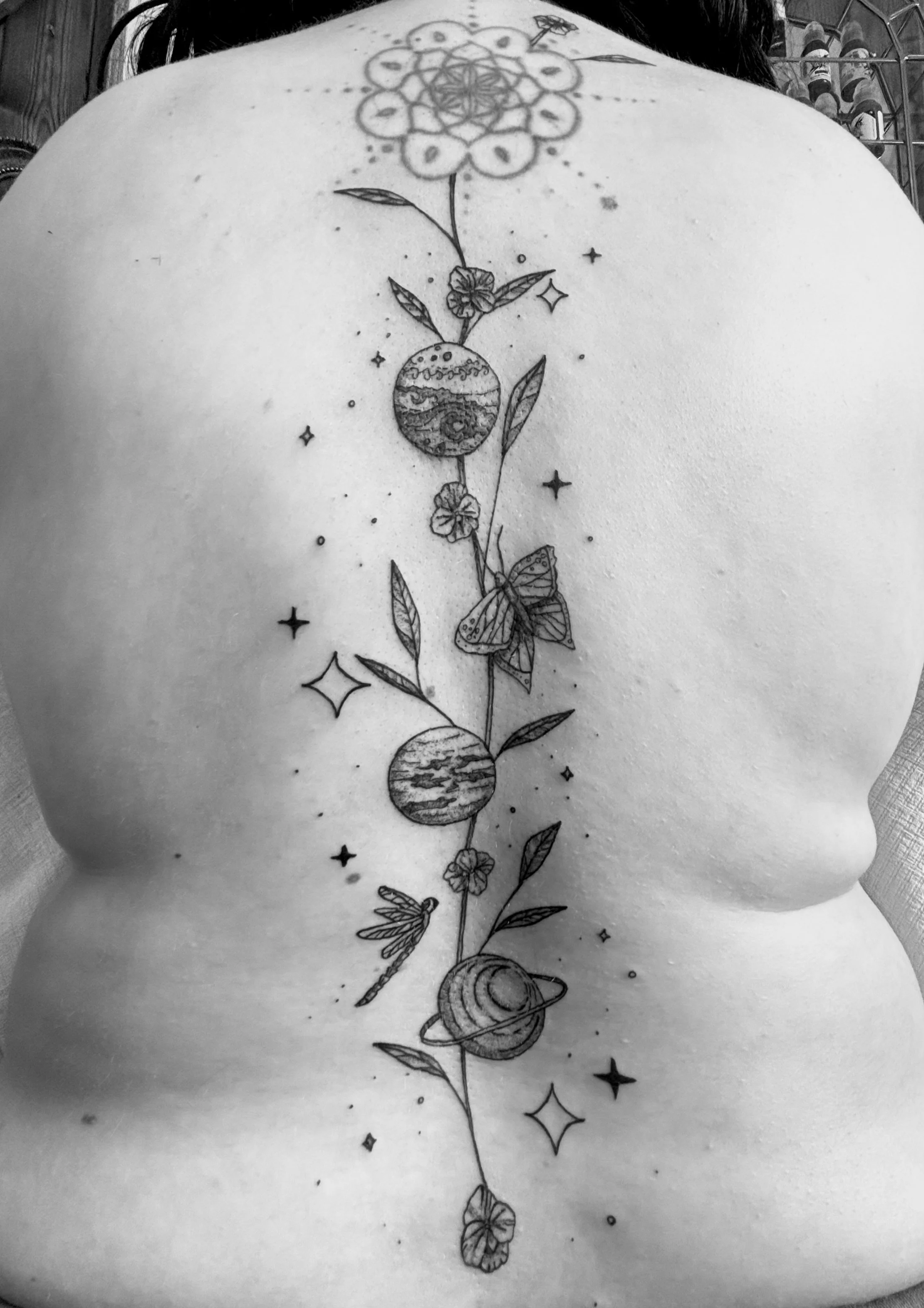 fineline back planet tattoo