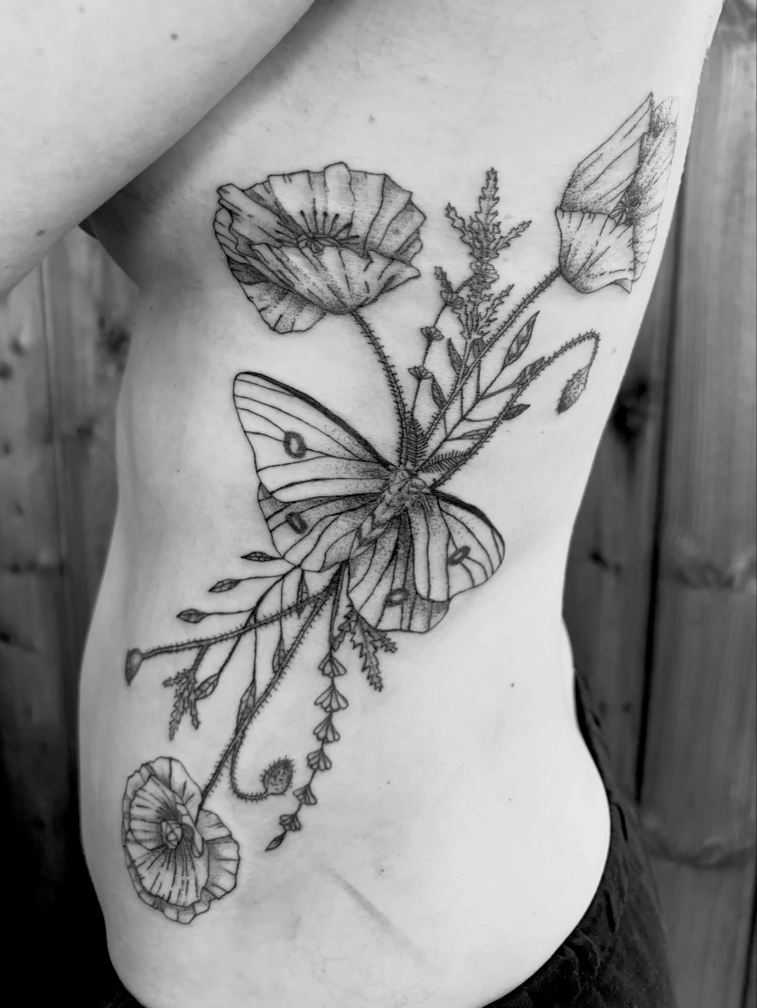Fineline rib flowers and moth tattoo
