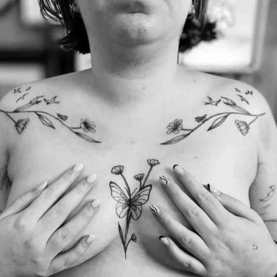 fineline chest butterfly tattoo