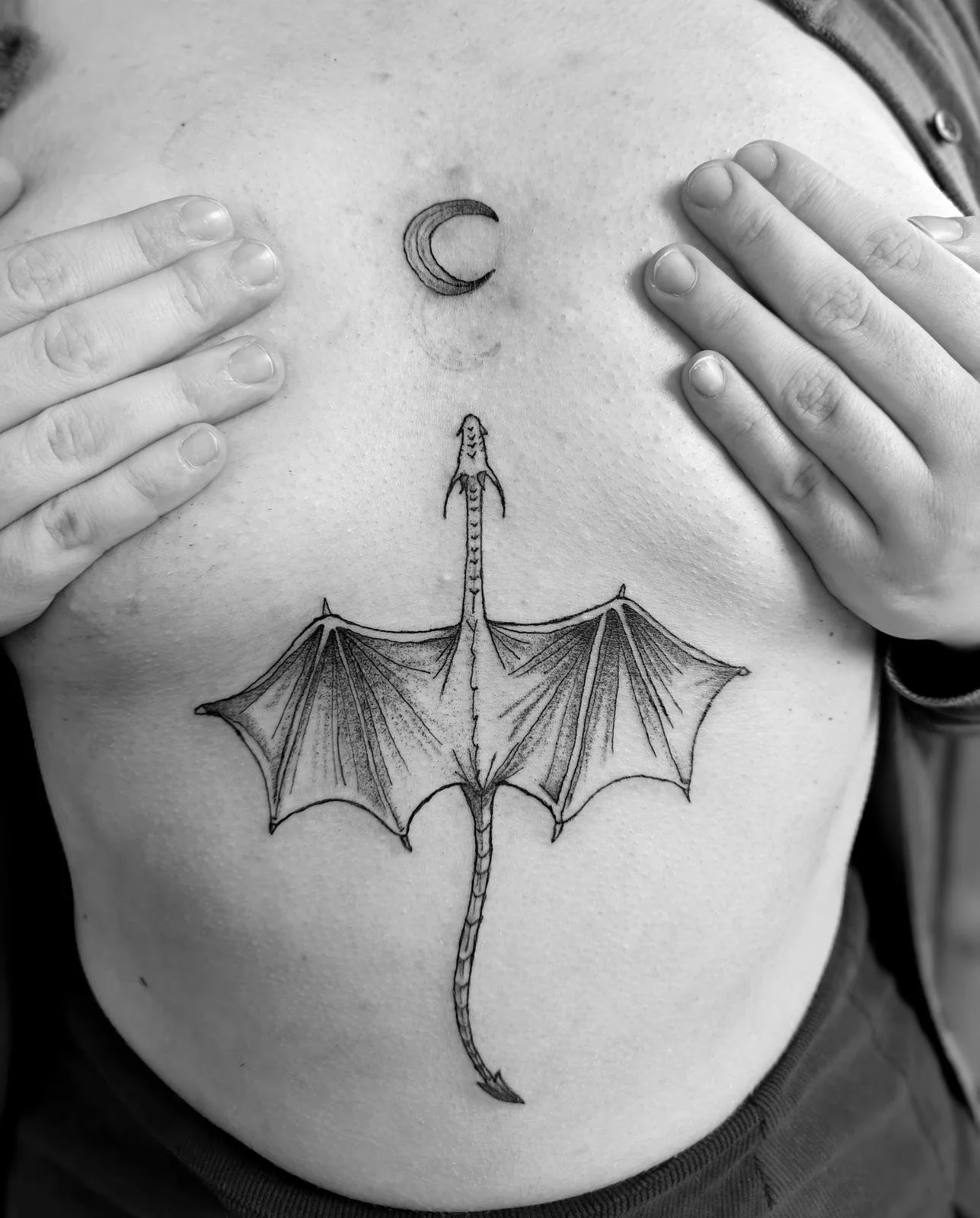fineline dragon chest tattoo