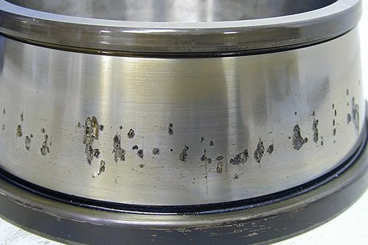 Close-up of a metal wheel rim with visible rust and corrosion.