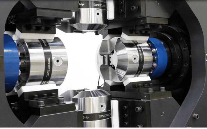 Close-up of a precision robotic or mechanical device with cylindrical metallic components, used for manufacturing or experimental purposes.