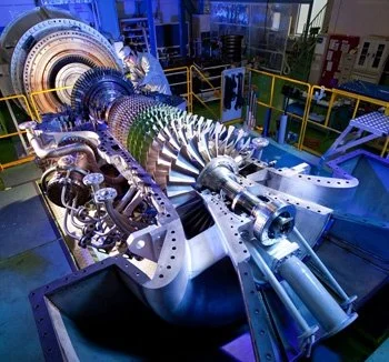 Large industrial jet engine on assembly or testing stand inside a factory