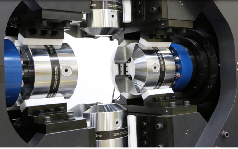 Close-up of a precision robotic or mechanical device with cylindrical metallic components, used for manufacturing or experimental purposes.