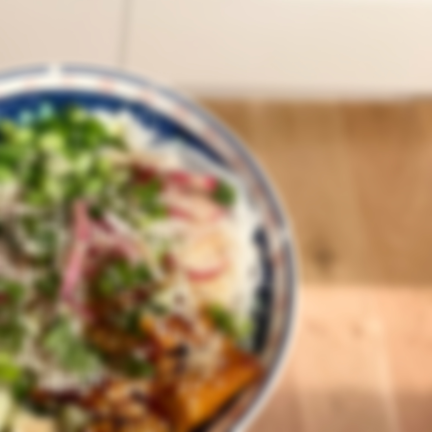 A colorful salad in a bowl on a wooden table.