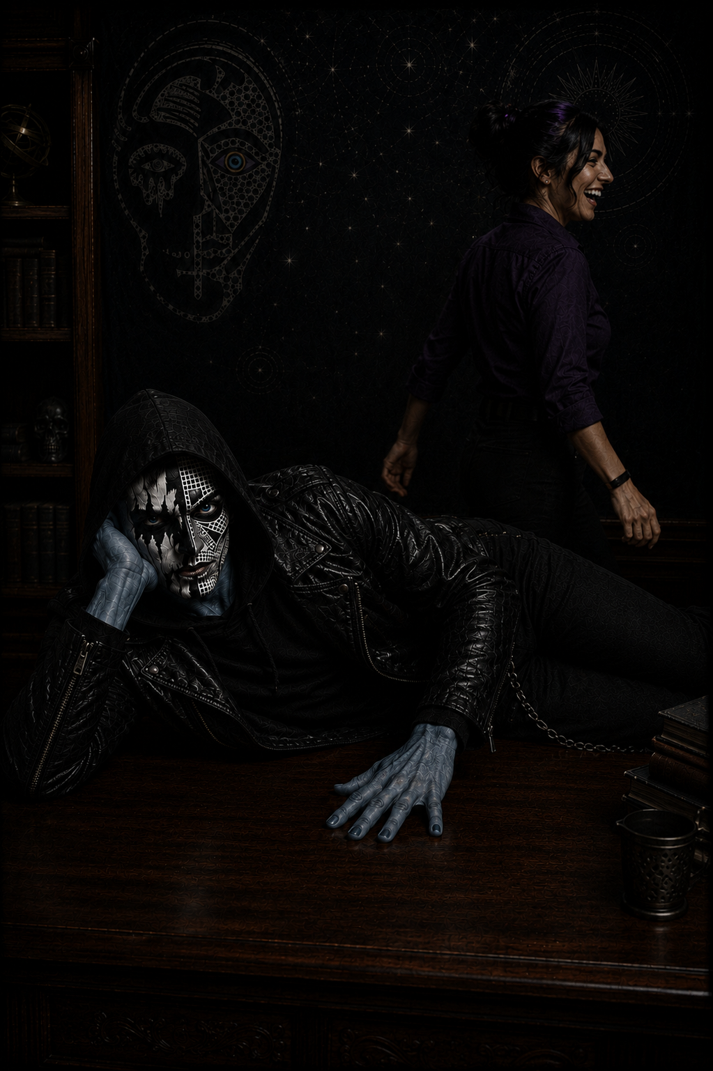 Professor Logic walks away laughing as Tenet lounges across the desk, still confused after mistaking black metal face paint for people from his home world. Humorous classroom moment from The Canis.