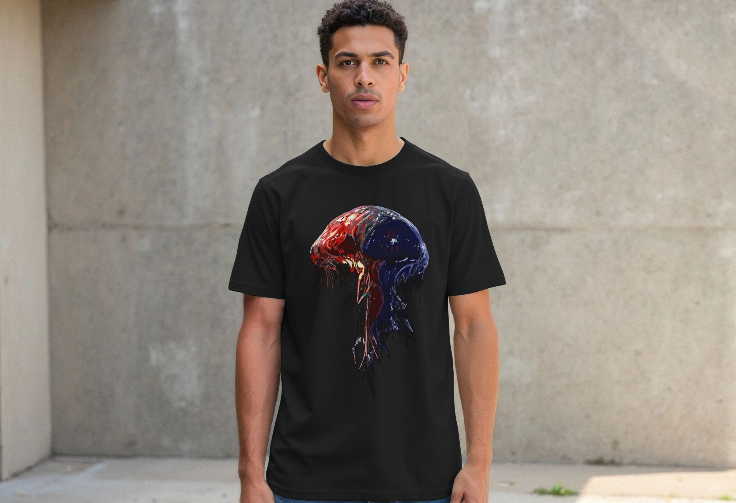 Model wearing the black Spineless organic cotton graphic T-shirt by Mongrel Logic, featuring a red, blue and black jellyfish-like entity with dripping tentacles.