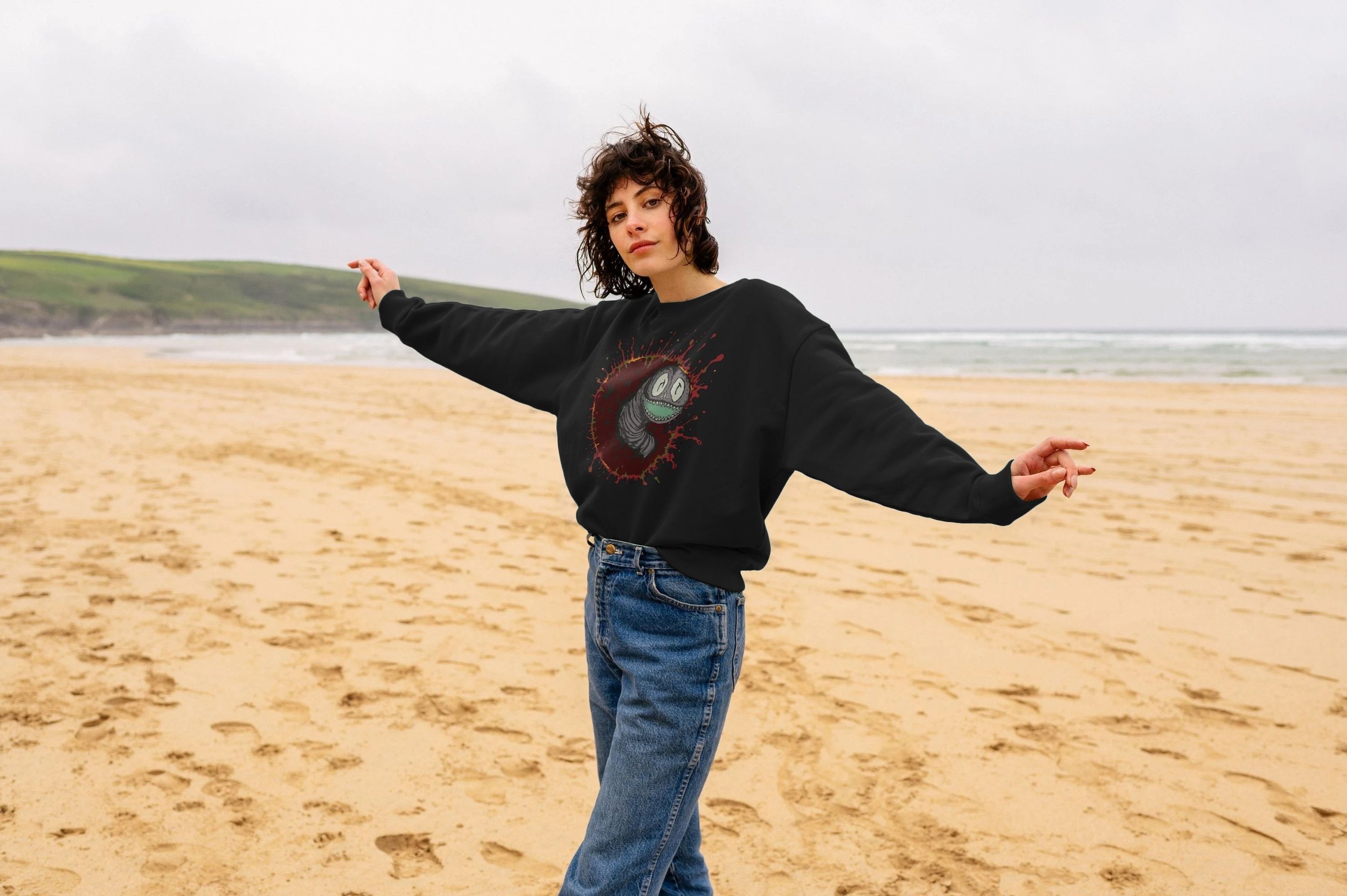 Model wearing the black Sun Eater organic cotton sweatshirt by Mongrel Logic, featuring a smiling star maggot inside a red-orange cosmic sun burst.