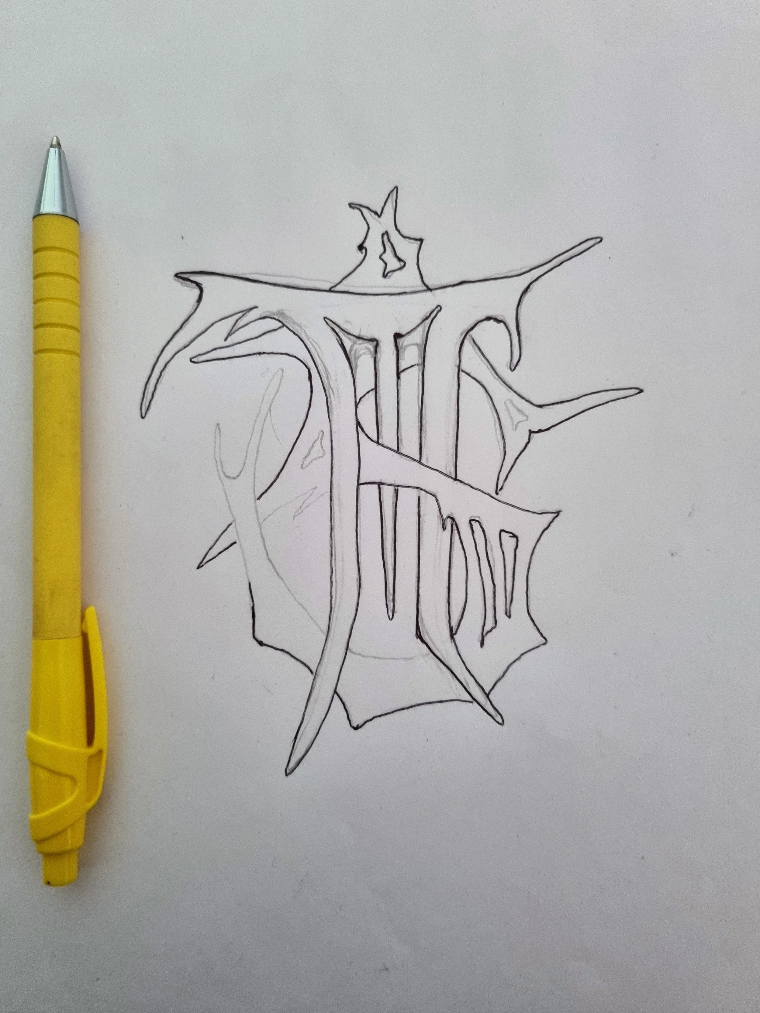 Mongrel Studio Logo Sketch with the pen I was using captured in the photo