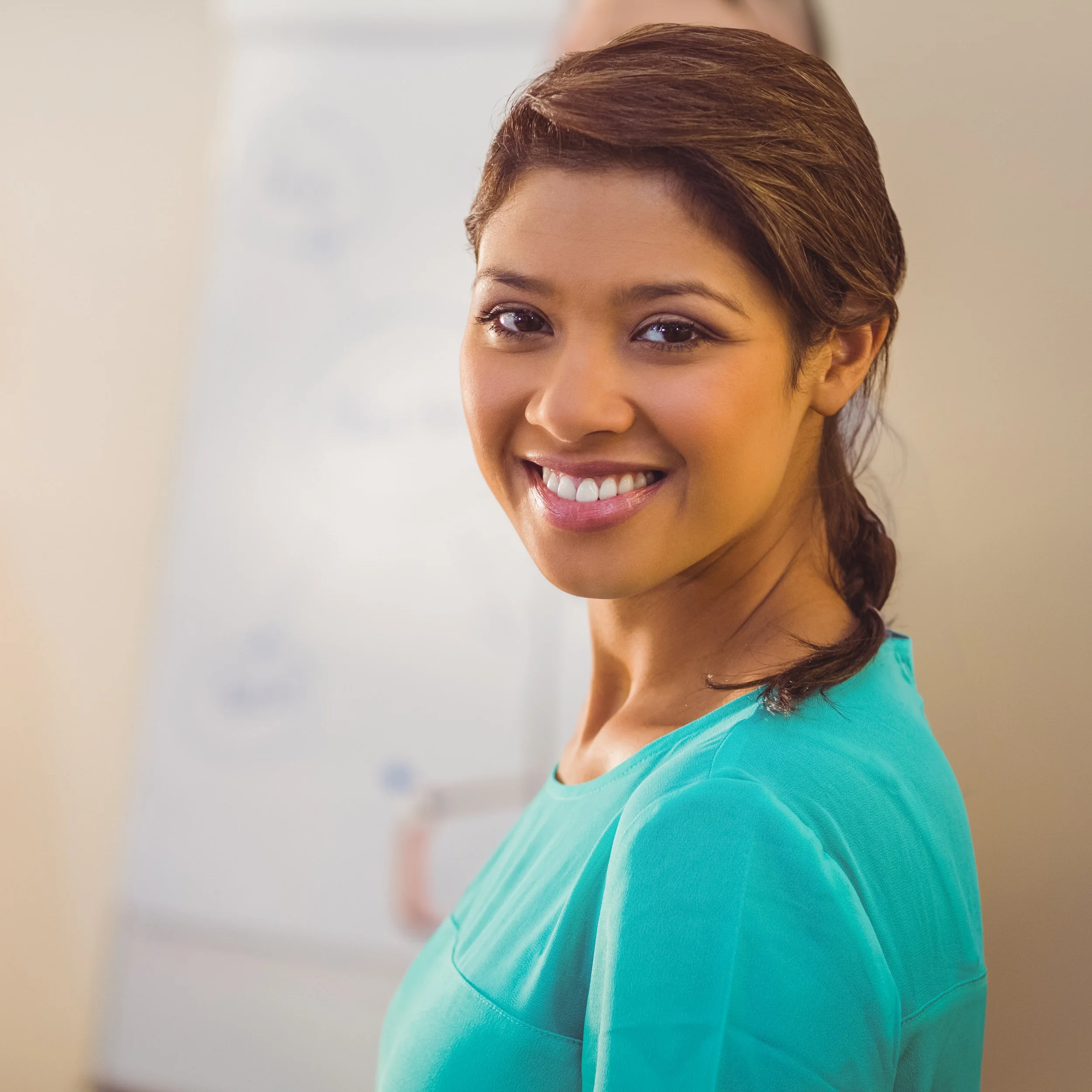 smiling-woman-in-office-standing-confidently-near-2025-04-03-00-21-16-utc.jpg