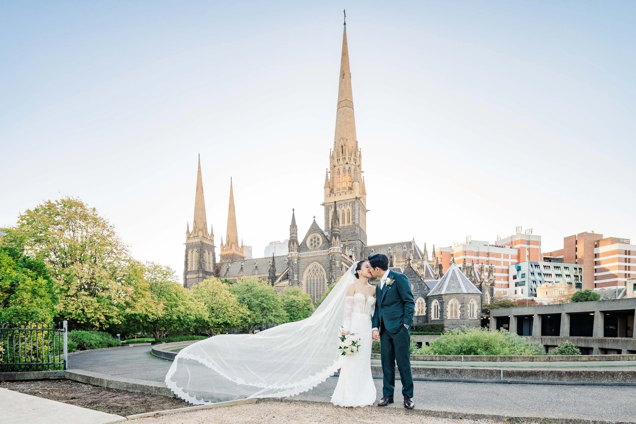Melbourne wedding couple photographed in front of St Patrick's Cathedral by Sherman Tan Studio.
