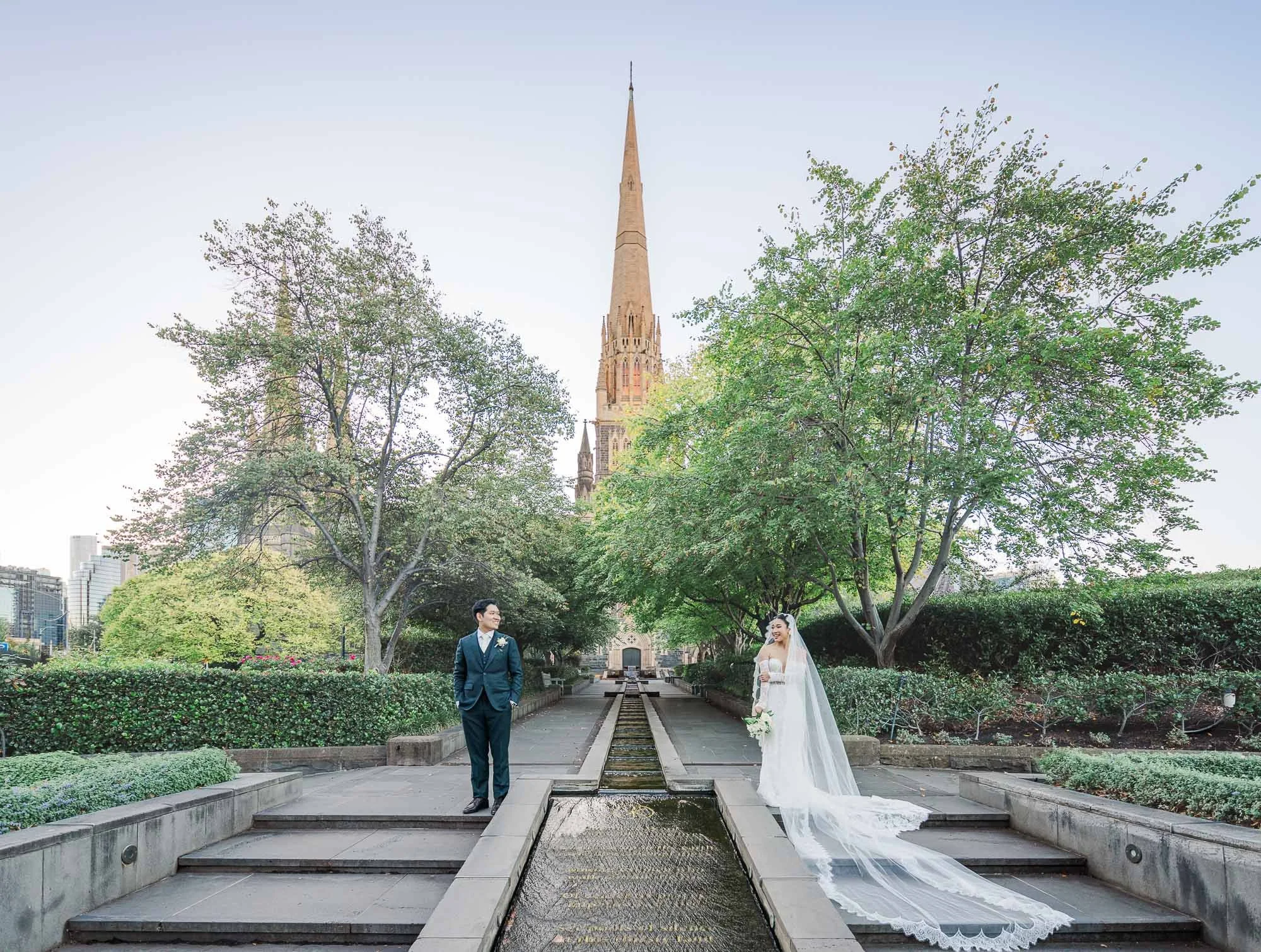 Stunning Melbourne wedding photography portrait of a bride and groom in an elegant outdoor setting in front of st patricks cathedral with soft natural light