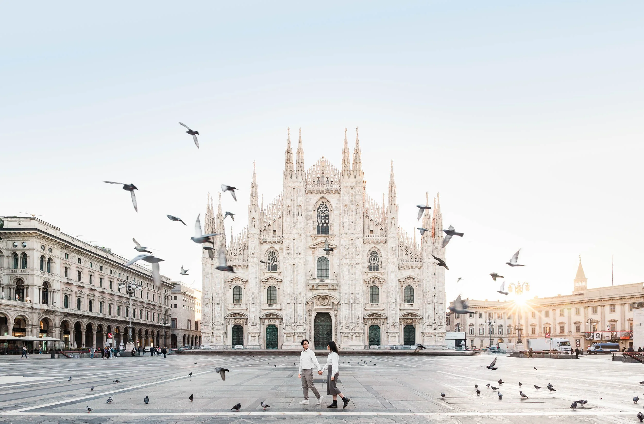 Melbourne wedding photographer award finalist image of a couple in Milan at sunrise with Duomo cathedral and birds in flight.