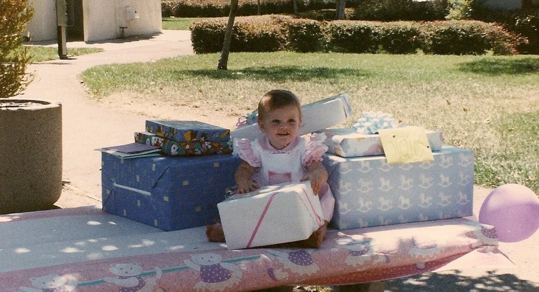 Tiare with presents at 1st birthday
