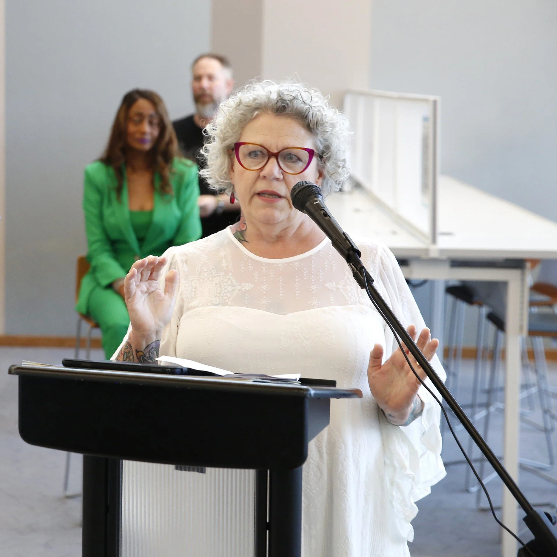 Photo of Sondra Kretschmar giving statements at the dedication ceremony for public arts commission at San Marcos Public Library. Bill Hutson-inspired stained glass panels Commissioned by San Marcos Arts Commission