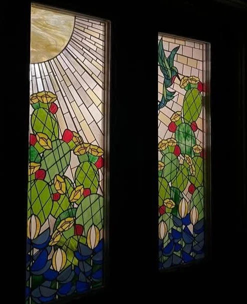 Double door custom installation of stained glass panels in a residential home featuring hummingbird, cactus, bluebonnets, sunshine by Esaltare Arts artist, Sondra Kretschmar