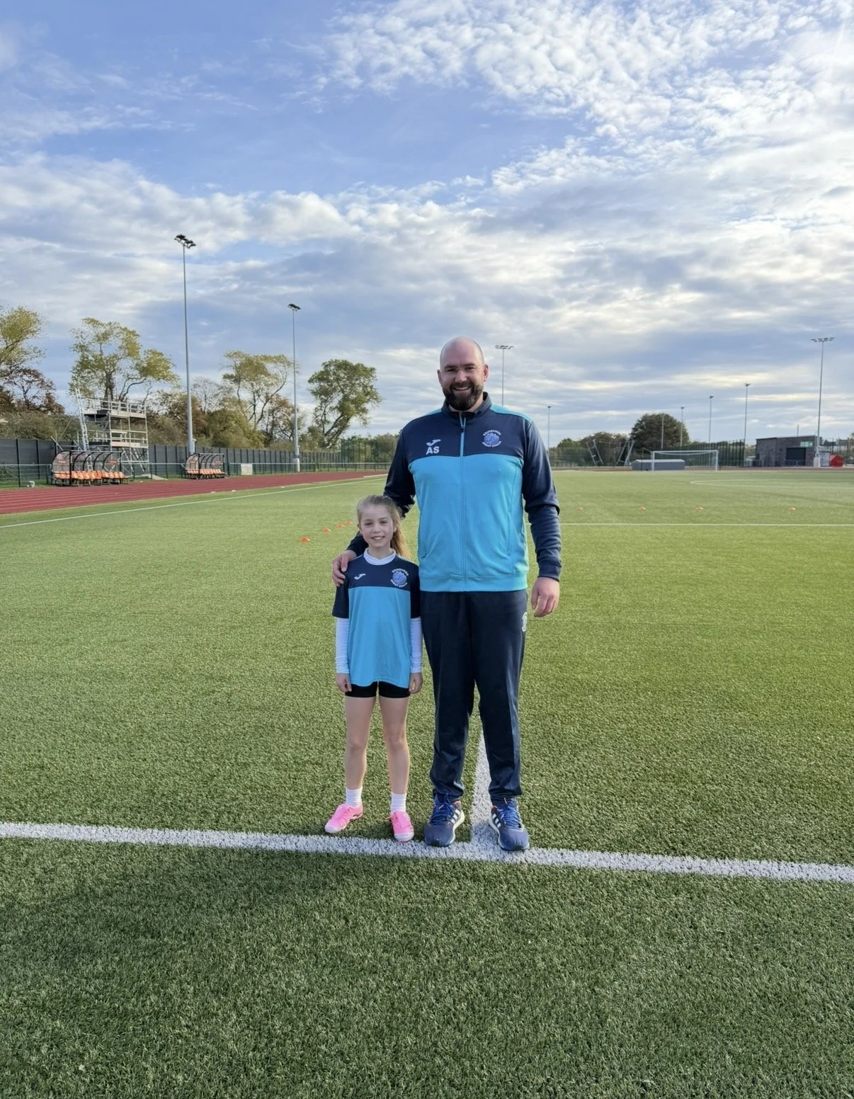 Sprint coach Allan Smith with a young female footballer during a speed training session at Meadowbank Stadium in Edinburgh
