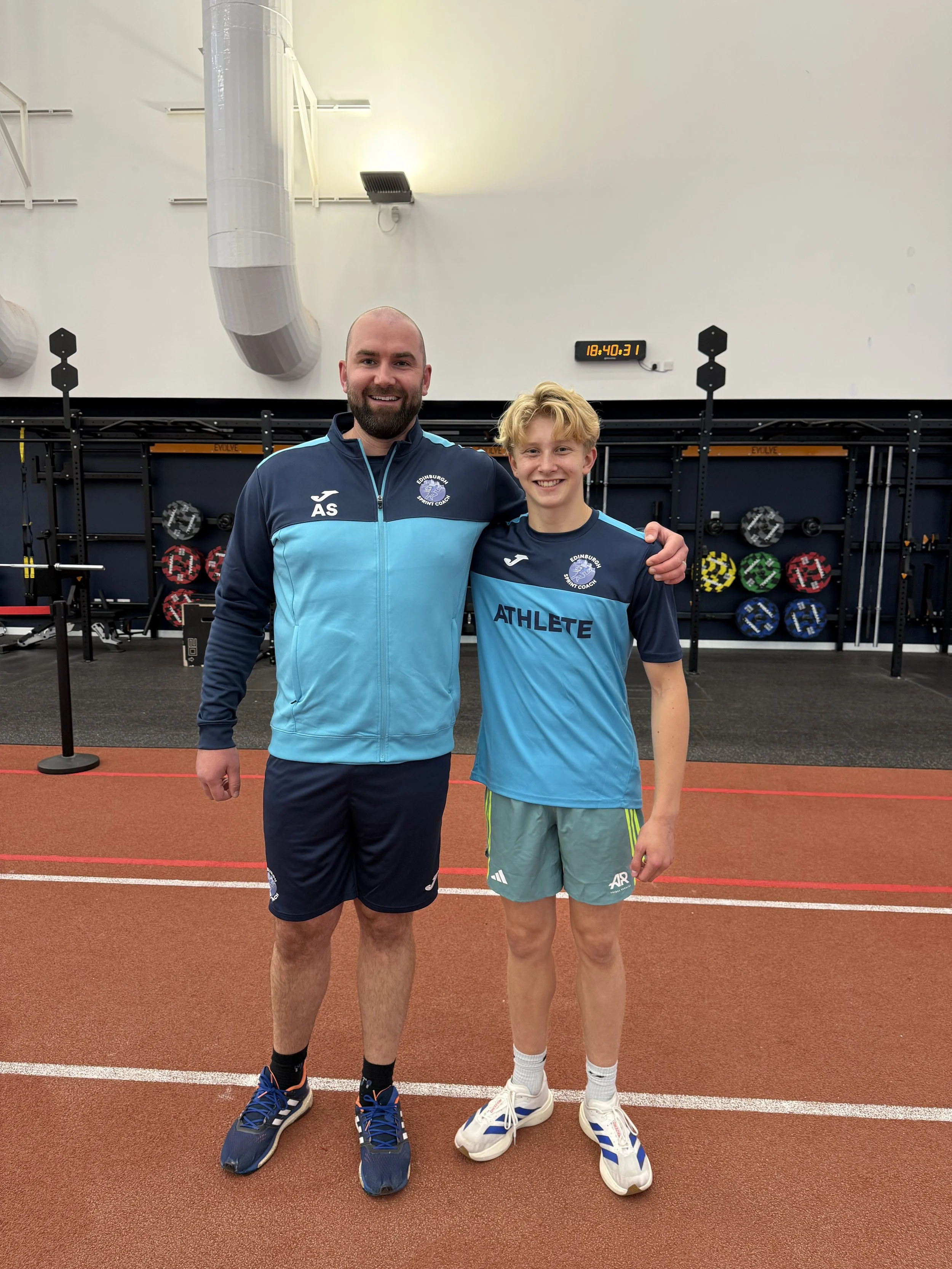 Sprint coach Allan Smith with a young male athlete during a speed training session at Meadowbank Stadium in Edinburgh