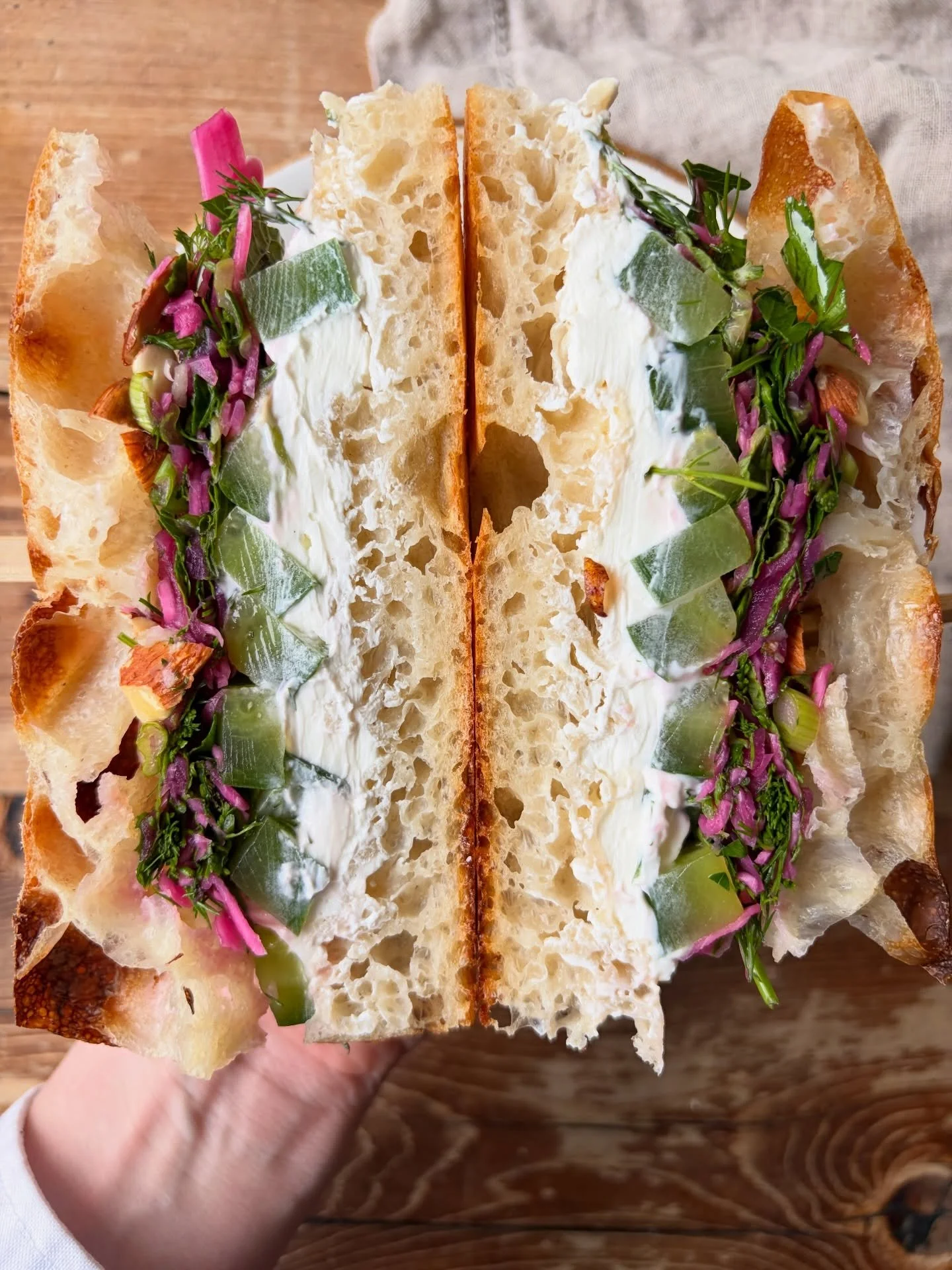 Meet your new favorite lunch! Our Veggie Focaccia layers compressed cucumber, creamy labneh, pickled cabbage, herb salad, almonds, and honey, all on fluffy housemade focaccia. 

Fresh, bright, and built to satisfy.