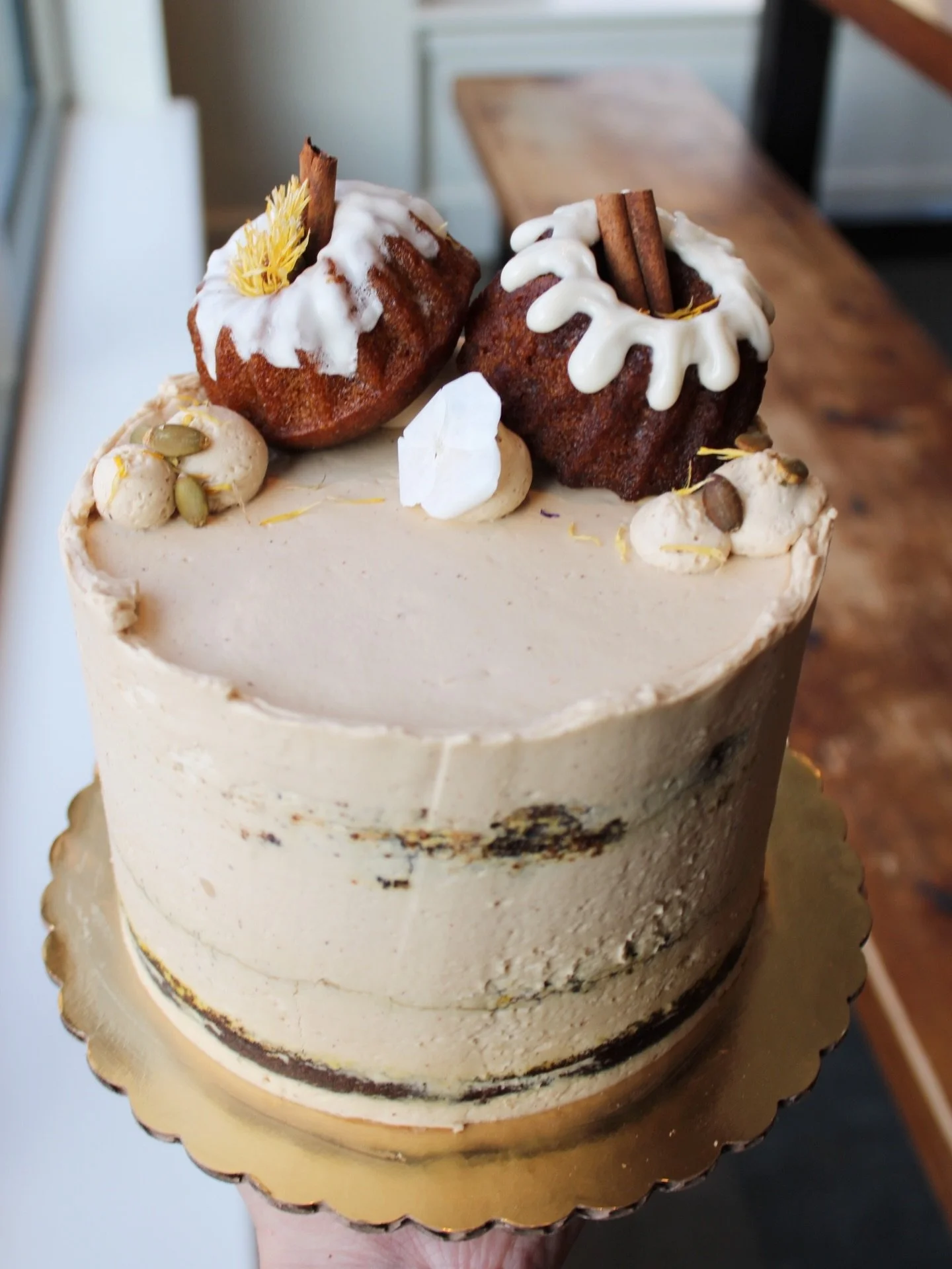 A cake topped with tinier cakes? We regret nothing!

Pumpkin chai layer cake has hit the cases. Spiced pumpkin cake, chai whip, brown sugar frosting, and a little bundt parade on top. 

Grab a slice now, or bring home a whole 6&rdquo; mini cake to en