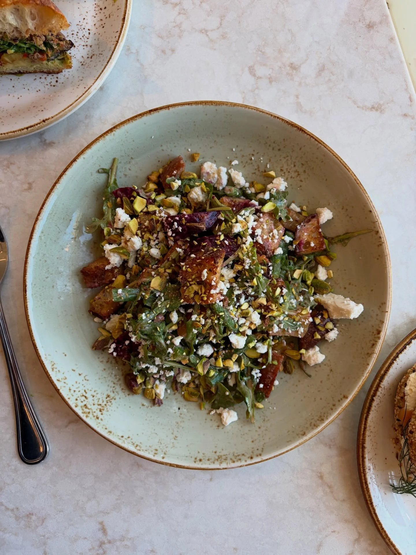 Our Beet and Feta Panzanella starts with red and golden beets, roasted until sweet and tender. We toss them with haricots verts, peppery arugula, and creamy feta, then add croutons made from our own sourdough and a handful of pistachios.

A sherry sh